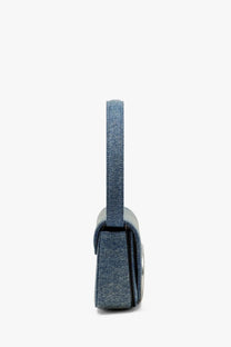 Diesel women’s denim shoulder bag in blue with denim texture, sleek minimalist design, and metallic hardware accent