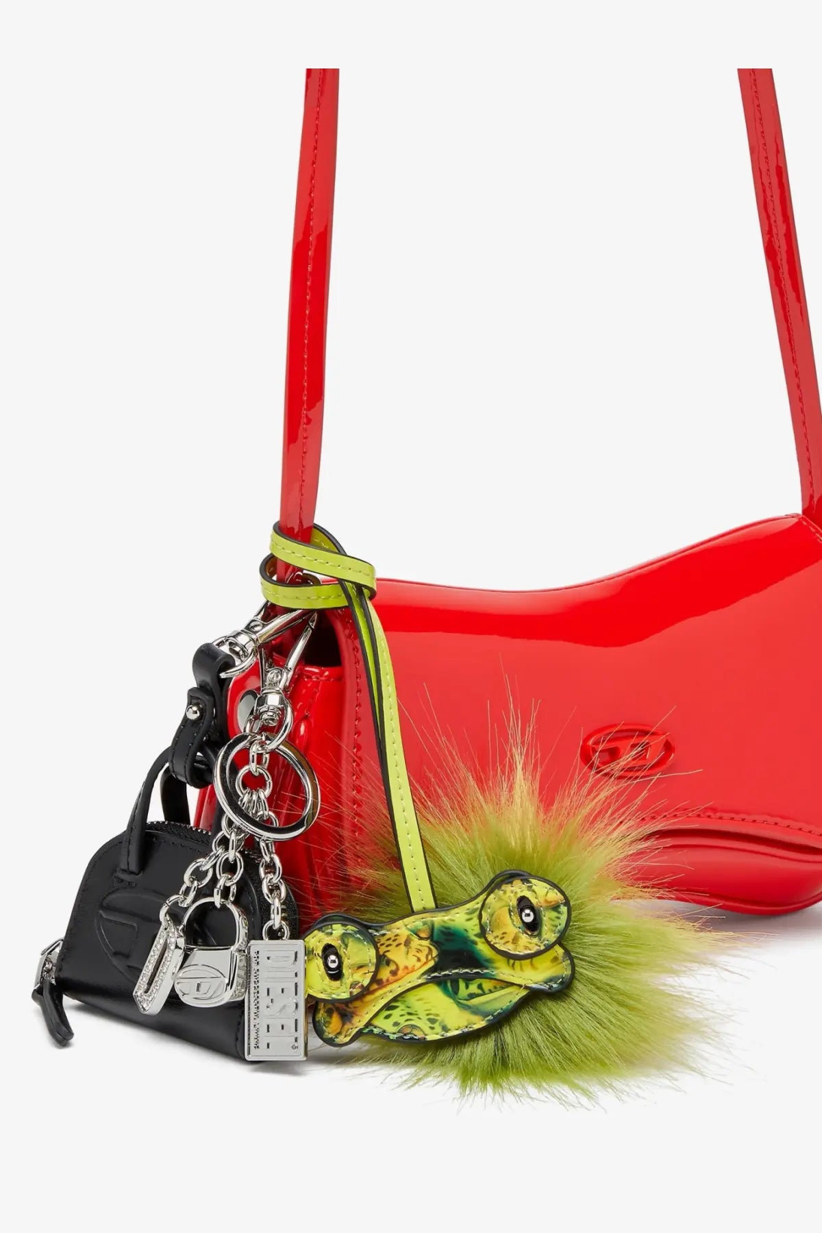 A vibrant red glossy handbag with lime green strap and Diesel women’s dome charms pvc keychain black accessories