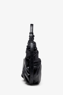 Black glossy leather Diesel women’s grab hobo bag with structured ruched design and adjustable strap for crossbody use