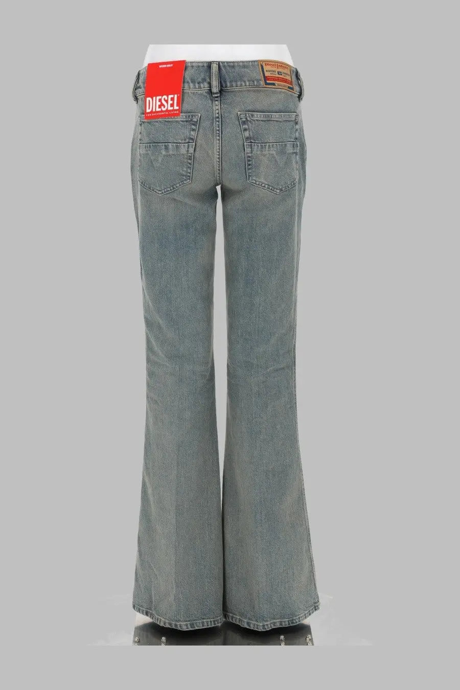 Back view of diesel women’s bootcut gray denim jeans with red diesel label on waistband