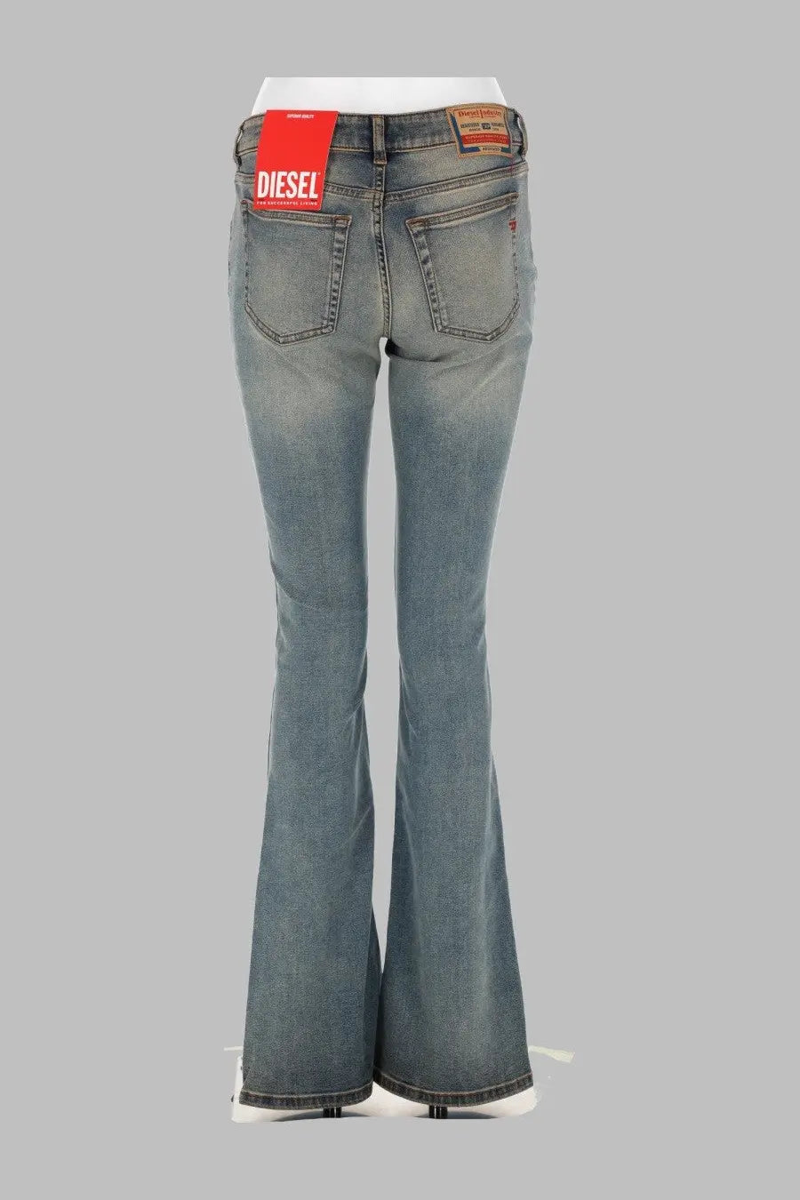 Backside of diesel women’s jeans ebbey blue light-wash denim flare jeans with classic back pocket and red diesel tag