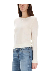 Cream-colored long-sleeved knit top with subtle logo on chest made from jersey fabric by Diesel women’s Alinesa white collection