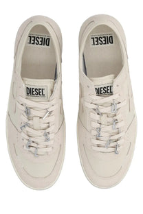 Cream-colored Diesel women’s Leroji low sneaker with metallic letter charms on laces and branded labels inside