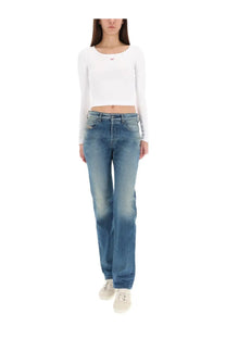White long-sleeved crop top with small embroidered logo paired with diesel women’s mine blue jeans