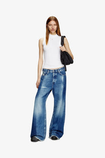 Wide-leg blue denim jeans with faded wash and frayed hems paired with diesel women’s white viscose tank top