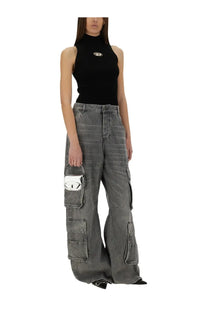 Diesel women’s onervax top black paired with gray denim cargo pants featuring multiple pockets and silver pig pouch
