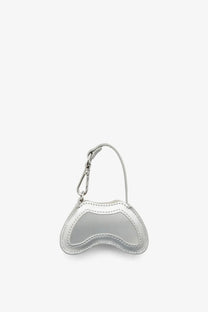 Diesel women’s play charm shiny keychain mini bag in silver metallic with glossy finish and stitched curved edges
