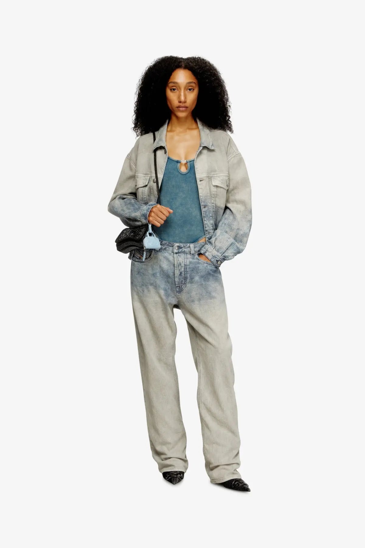 Diesel womens play crossbody xs shoulder bag black paired with light blue denim jacket with faded distressed finish and rolled sleeves
