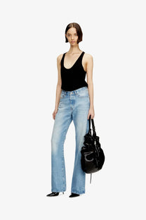 Black glossy leather tote bag with structured slightly slouched silhouette and visible top zipper closure for everyday use