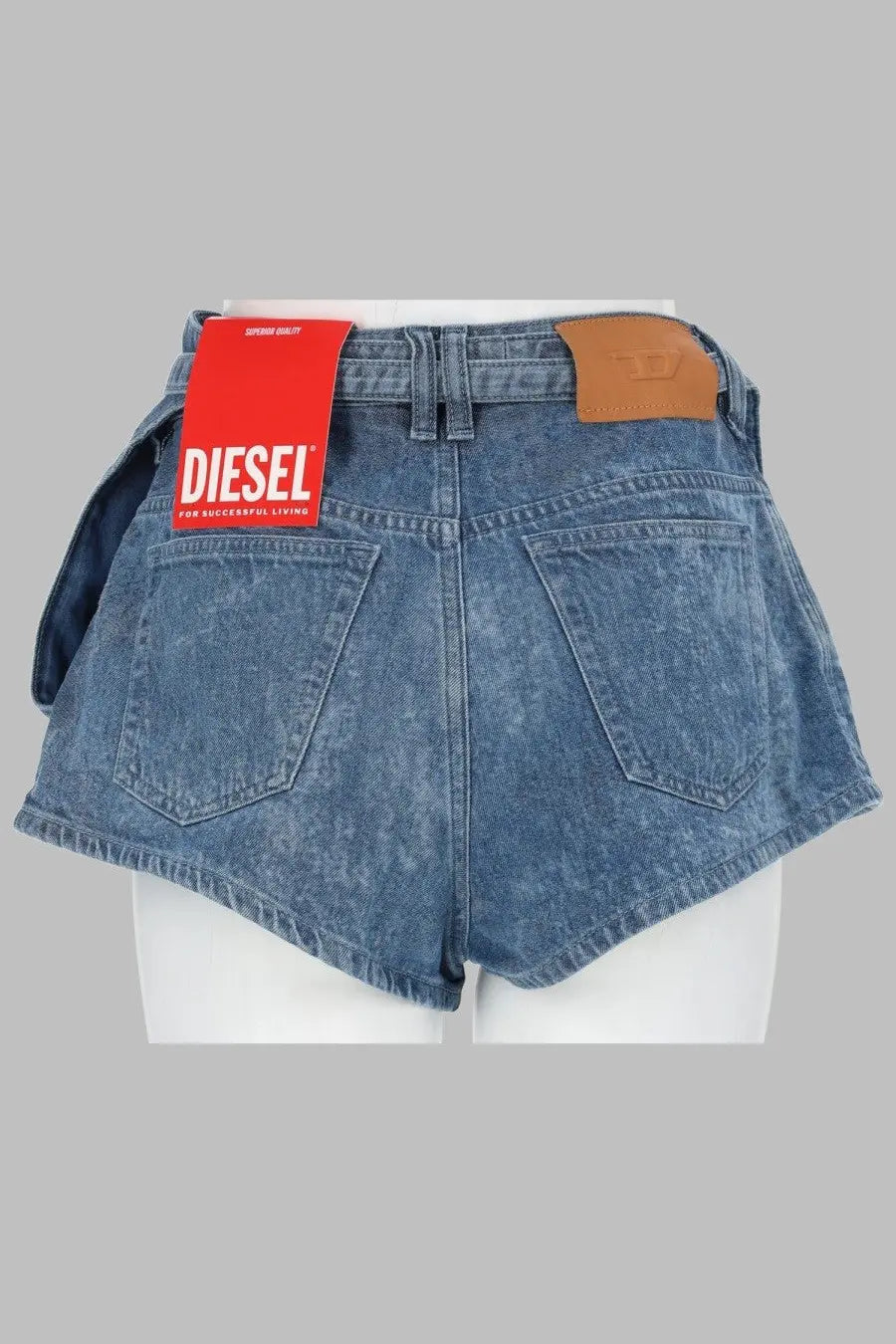 Blue denim shorts with a red diesel tag and brown leather patch.
