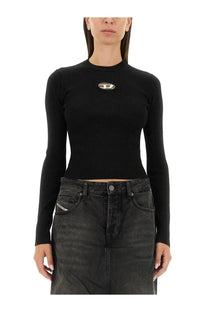 Diesel women’s black ribbed long-sleeve top with metallic logo emblem on chest made of soft fabric