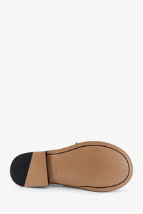Tan leather sole of Dior men’s Archie leather loafers black with black rubber heel and Dior branding visible on the back side