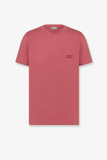 A soft rose-colored dior men’s cotton t-shirt with minimalist design and subtle embroidered logo on the left chest