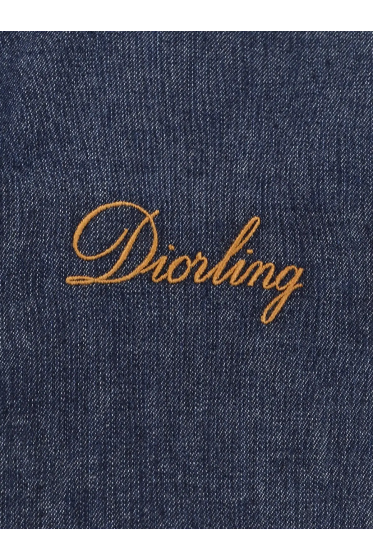 A navy blue denim jacket for men from Dior features golden thread embroidery spelling diorling on the back