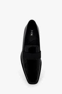 Black patent leather Dior men’s Palmarè loafers with sleek square toe and contrasting ribbed strap across the vamp