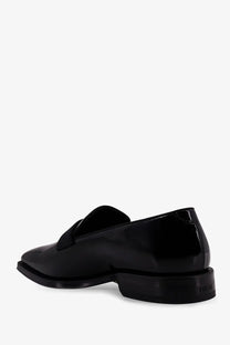 Black patent leather dior men’s palmarè loafers with sleek minimalist design and subtle logo embossed on the heel back side