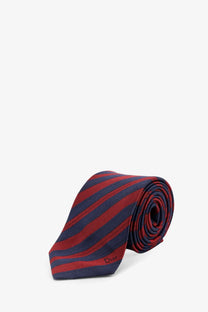Dior men’s silk tie featuring bold diagonal stripes in rich red and deep navy blue