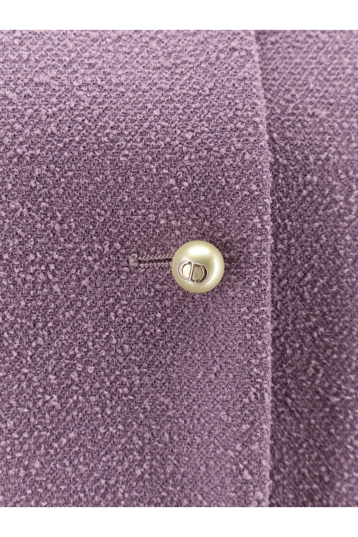 A pearl-like button with silver cd logo on a textured lavender bouclé virgin wool blend blazer by dior women