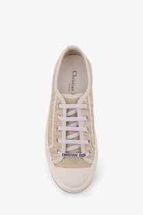 Beige canvas Dior women’s Walkndior sneaker with white laces and matching rubber sole in gold color scheme