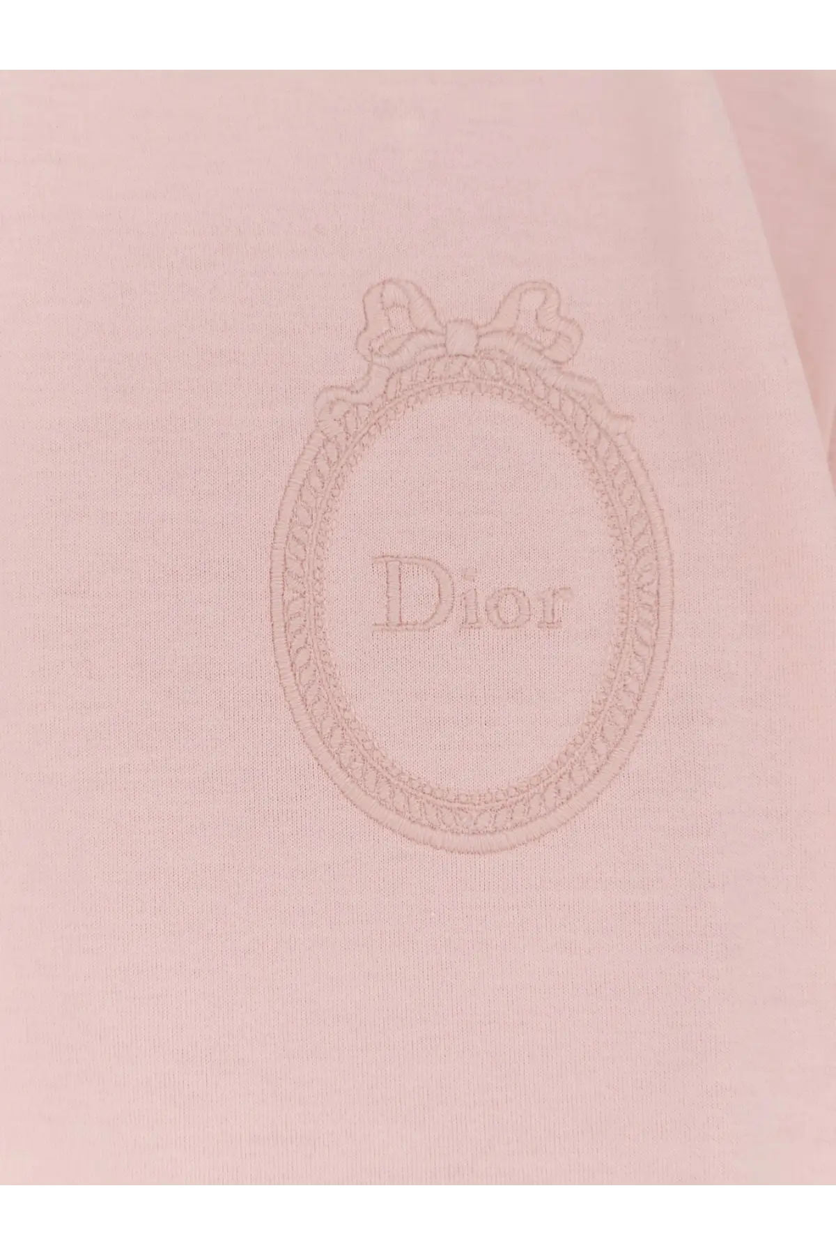 A delicate pink dior women’s cotton shirt with an embroidered oval logo bow and brand name in fine threadwork