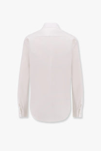 A crisp white Dior women’s cotton shirt with long sleeves, classic collar, and buttoned cuffs