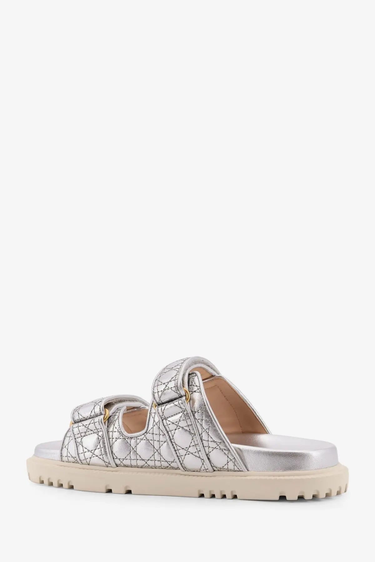 Dior women’s Dioract leather slide sandals in silver metallic with quilted texture and beige rubber sole