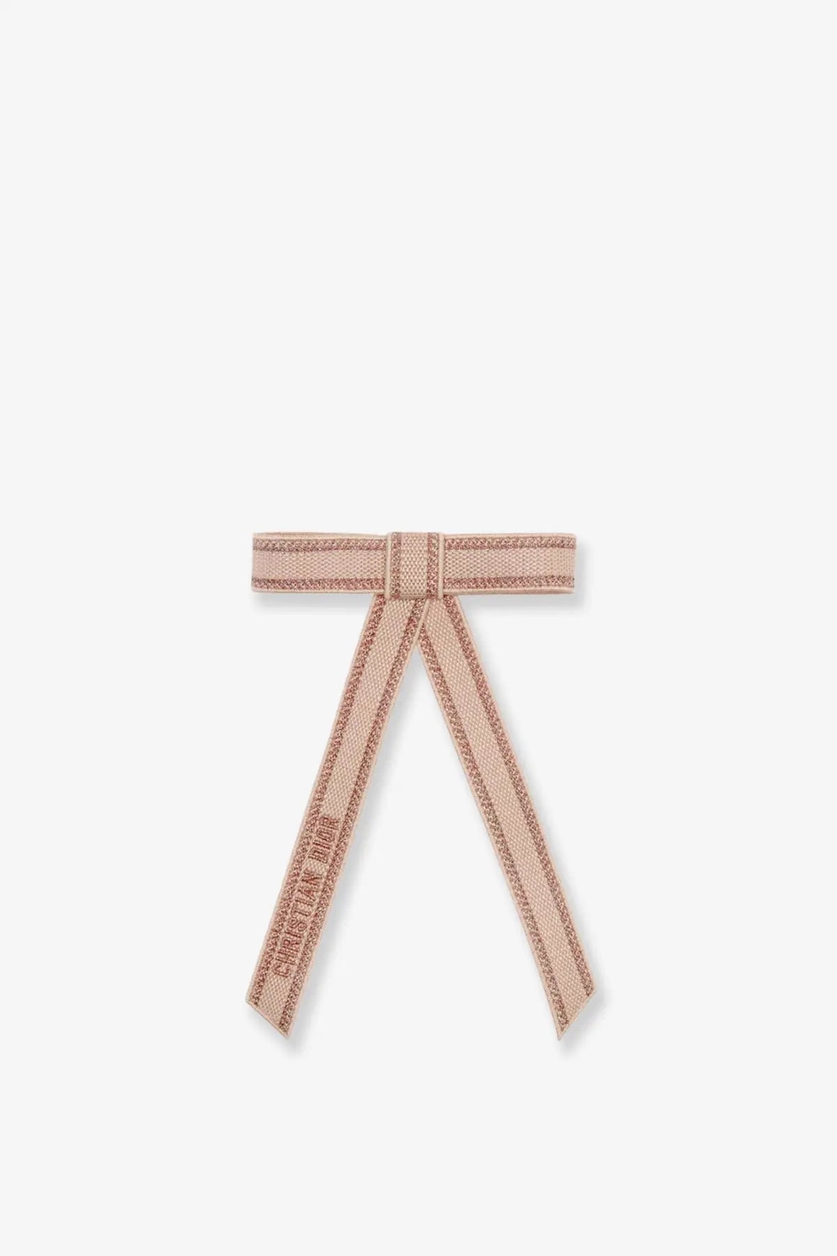 A delicate blush pink Dior women’s fiocco ribbon bow with textured weave and embroidered christian dior branding
