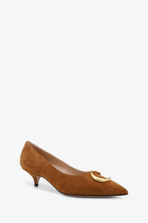 Dior women’s brown suede pumps featuring a tan upper with a gold-tone circular buckle at the toe