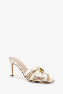 Dior women’s gold laminated leather mule sandal with slender heel and ornate gold buckle accent