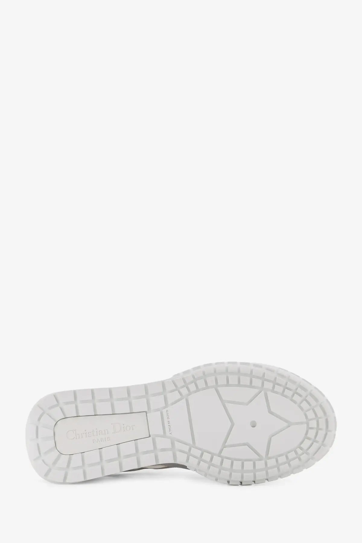 White rubber sole with star-shaped tread and christian louboutin label on dior women’s laminated leather silver sneakers