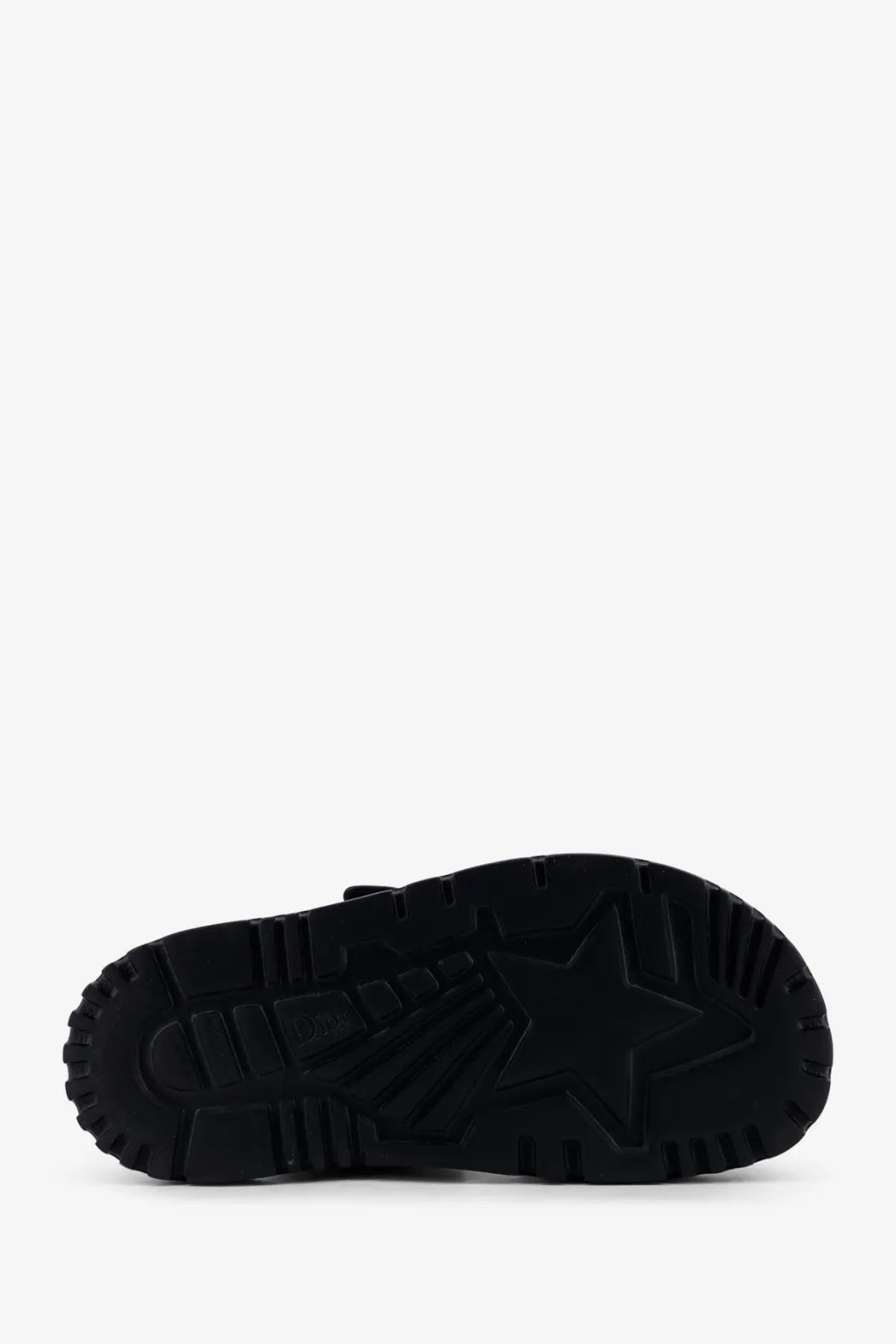 Black rubber sole with prominent star shaped tread pattern on blue dior women’s dior oblique denim dioract sandals