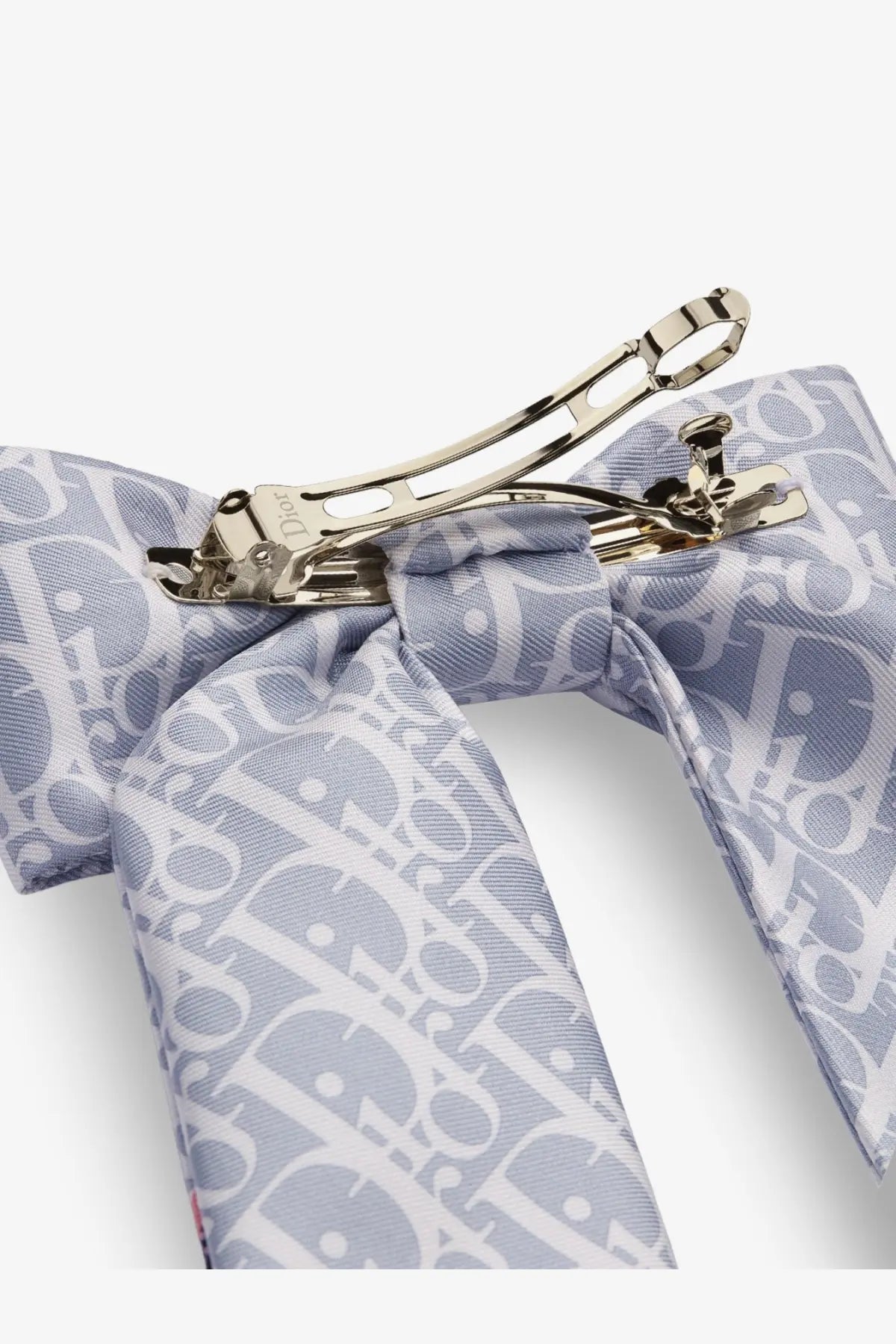 A light blue dior twist infini tartan print silk hair clip with a repeating white monogram and gold tone clip