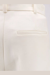 Dior women’s beige virgin wool tailored trousers with cream color sleek structured design and subtle stitching details