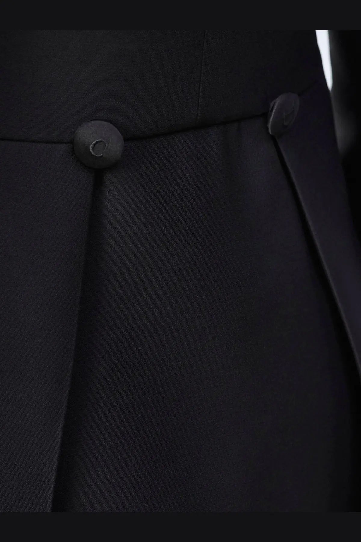Black pleated skirt with matching black buttons paired with Dior women’s wool and silk tuxedo blazer black