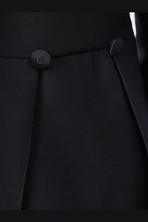 Black pleated skirt with matching black buttons paired with Dior women’s wool and silk tuxedo blazer black