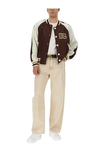 Brown and cream varsity jacket with gold embroidered dg logo on chest paired with dolce &amp; gabbana white bee and crown shirt
