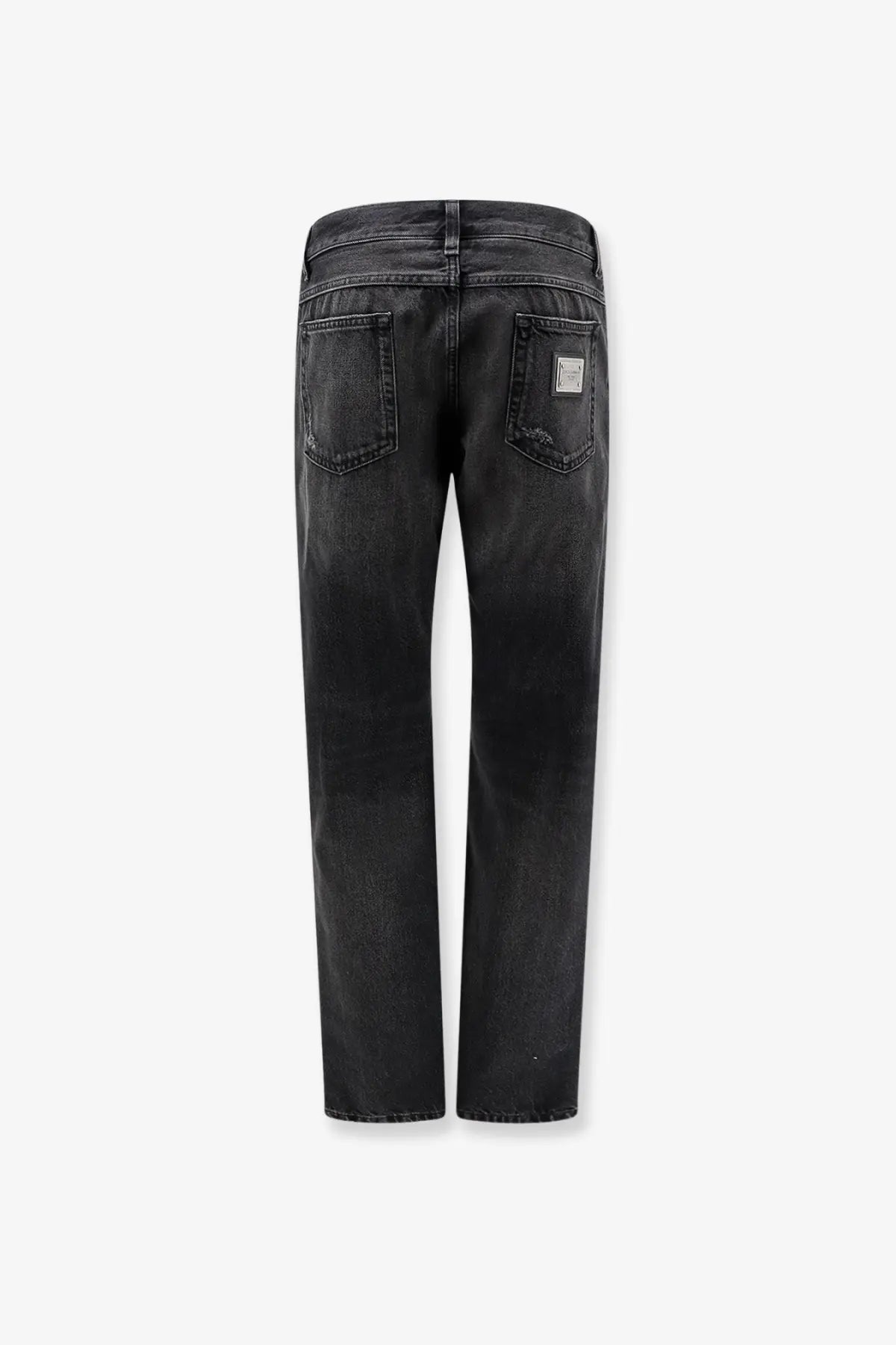 Back view of dolce and gabbana men’s black denim trousers featuring faded wash and subtle distressing on back pockets