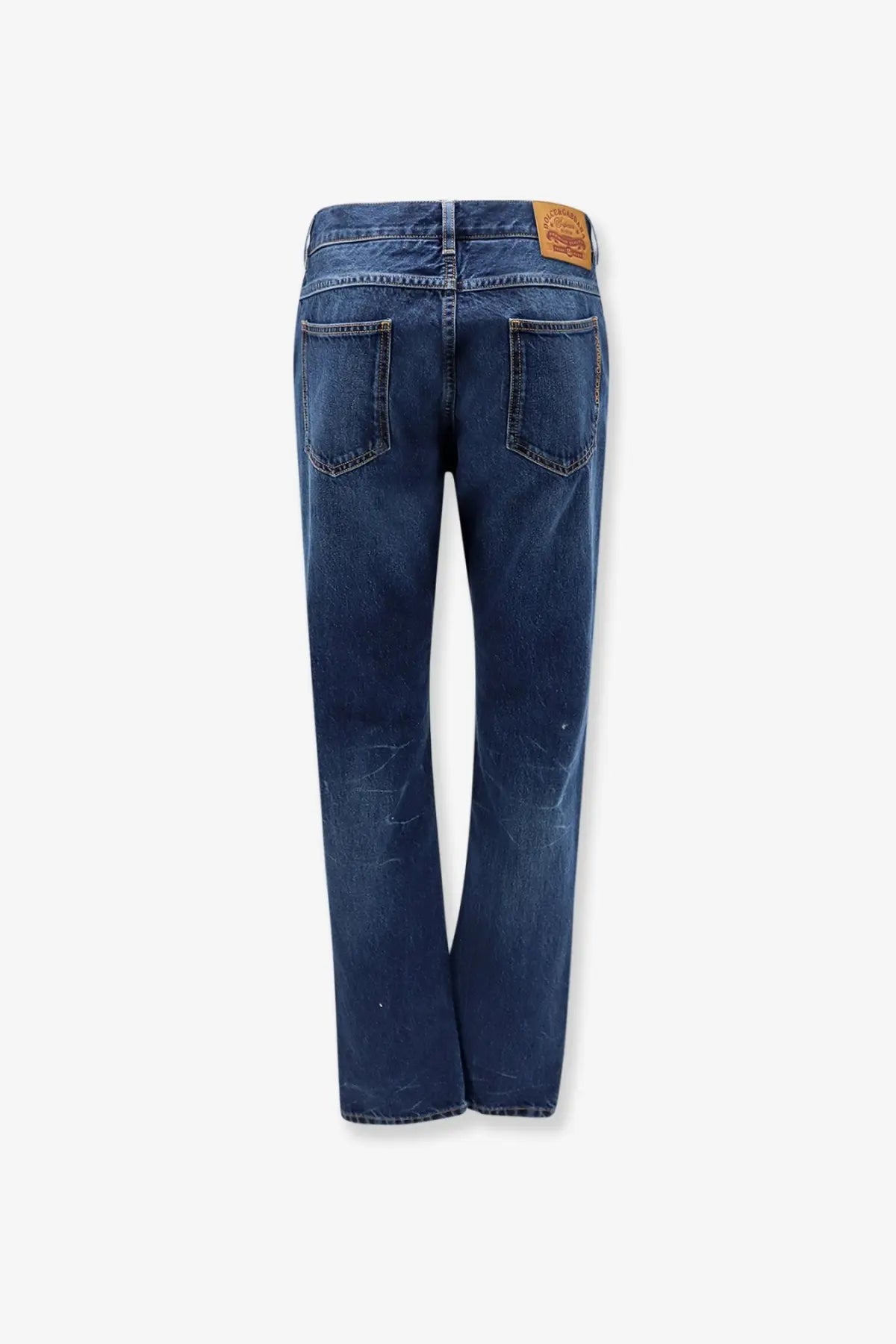 Dolce &amp; gabbana men’s blue denim jeans in dark blue with faded wash subtle distressing and brown leather patch back view