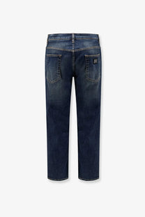 Dark blue dolce &amp; gabbana men’s denim jeans with faded wash and stitched back pockets visible from the back side