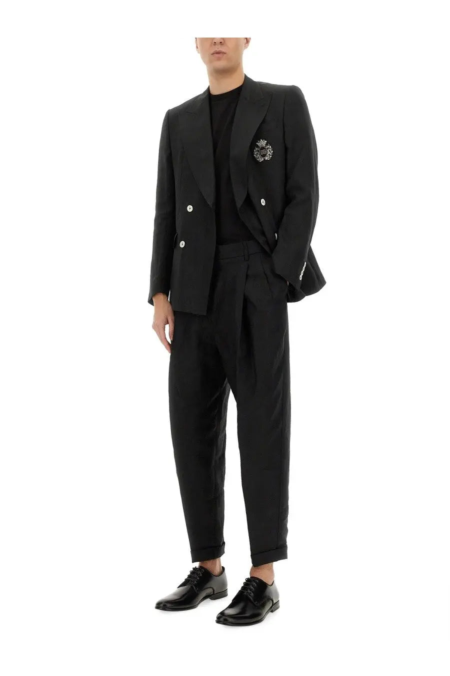Dolce &amp; gabbana black canvas pants paired with a black double-breasted blazer featuring silver buttons and an embroidered crest