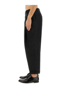 Dolce &amp; Gabbana men’s black canvas trousers with straight-leg cut and rolled cuffs paired with black dress shoes