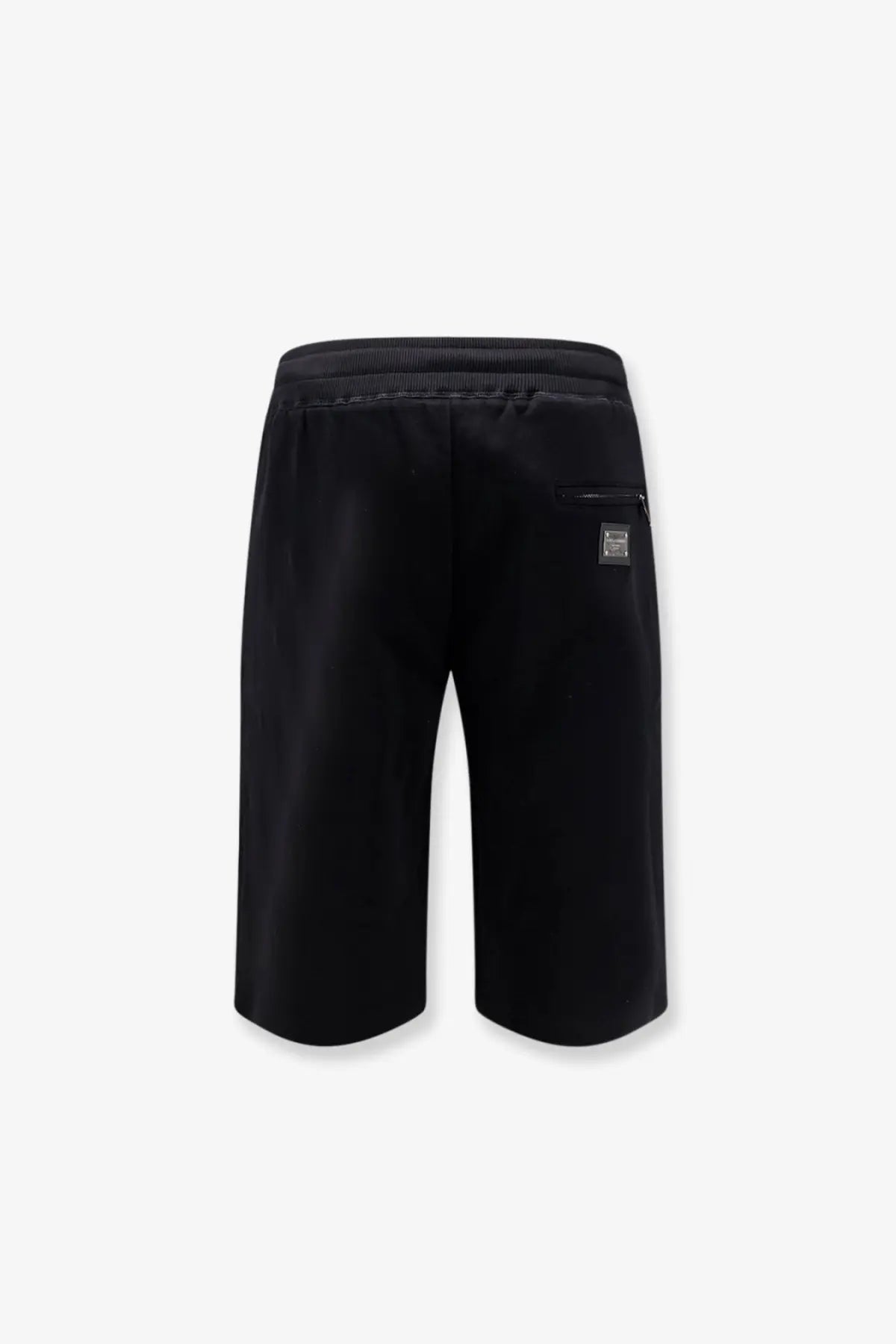 Back view of Dolce &amp; Gabbana men’s black cotton bermuda shorts with ribbed elastic waistband and logo patch on pocket