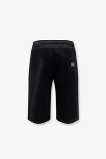 Back view of Dolce &amp; Gabbana men’s black cotton bermuda shorts with ribbed elastic waistband and logo patch on pocket