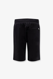 Back view of dolce &amp; gabbana men’s black cotton athletic bermuda shorts with drawstring waistband and white logo on pocket