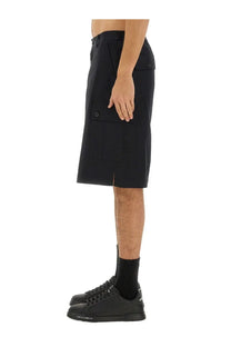 Dolce &amp; Gabbana men’s black cotton cargo bermuda shorts with multiple pockets and a front slit made from durable fabric