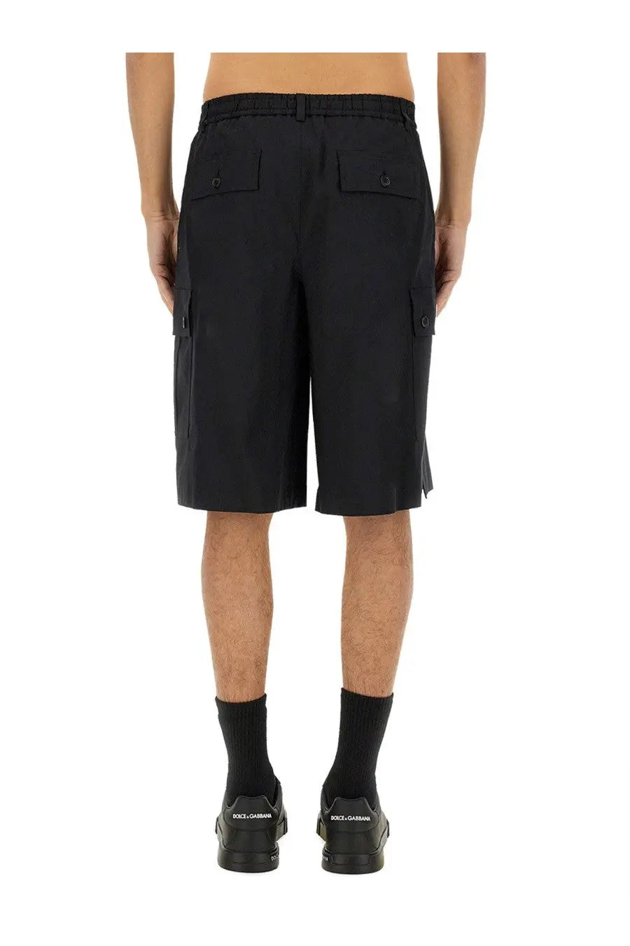Dolce &amp; Gabbana men’s black cotton cargo bermuda shorts featuring side pockets and buttoned flap details