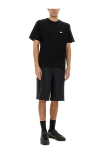 Black short-sleeved cotton t-shirt with small white logo on left chest paired with dolce gabbana cargo shorts