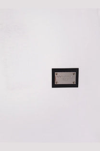 Black leather plaque with silver metal plate featuring dolce and gabbana logo on dolce and gabbana men cotton white shirt