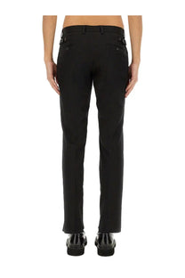 Black tailored cotton trousers by dolce and gabbana shown from the back with straight-leg cut and metallic button accents