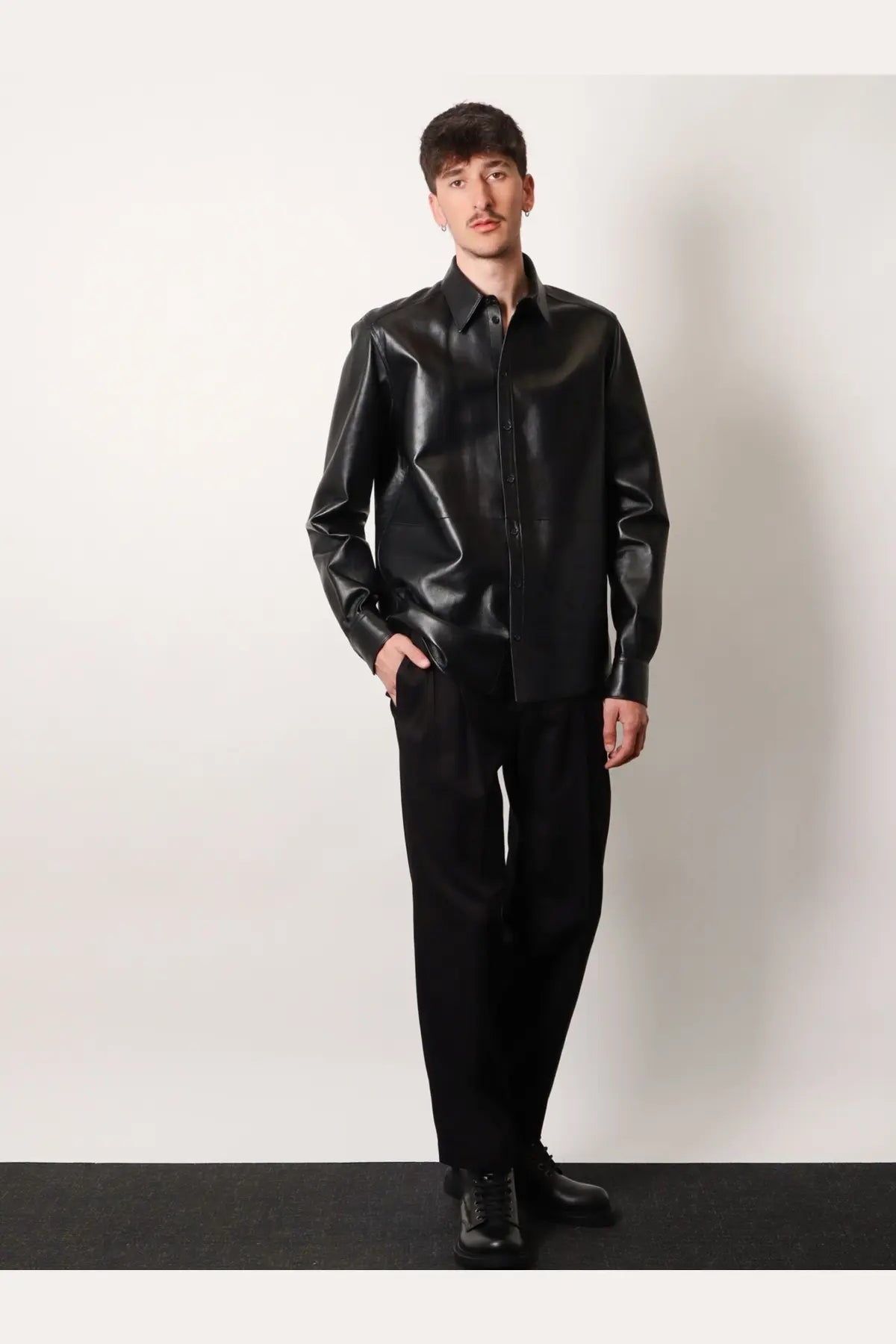 Black faux leather button-up shirt with glossy finish and classic collar paired with dolce &amp; gabbana cotton trousers black